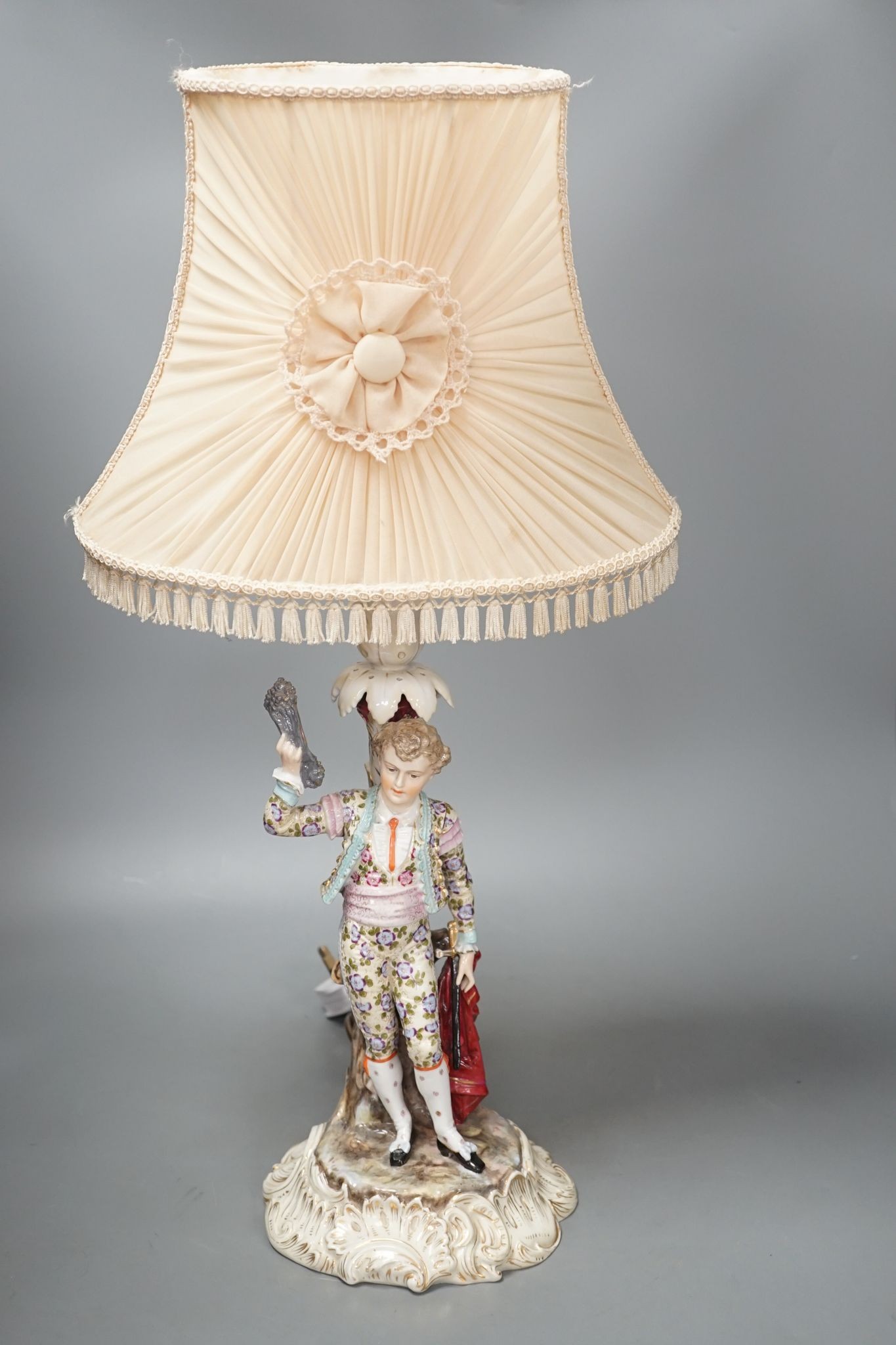 A German porcelain 'matador' lamp and shade 57cm total